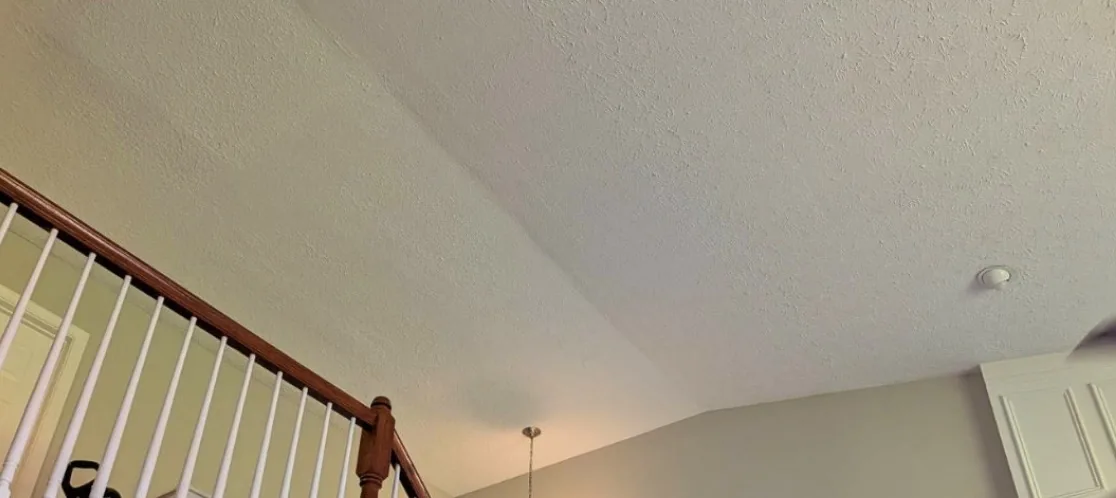 The same vaulted ceiling repaired and repainted with no stain